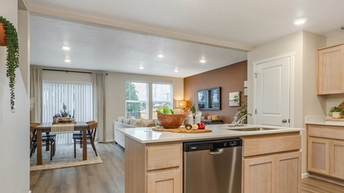 Blue Pearl Kitchen with light wood cabinets and stainless steel appliances