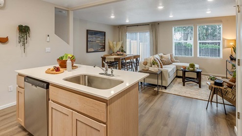 Blue Pearl Kitchen with light wood cabinets and stainless steel appliances