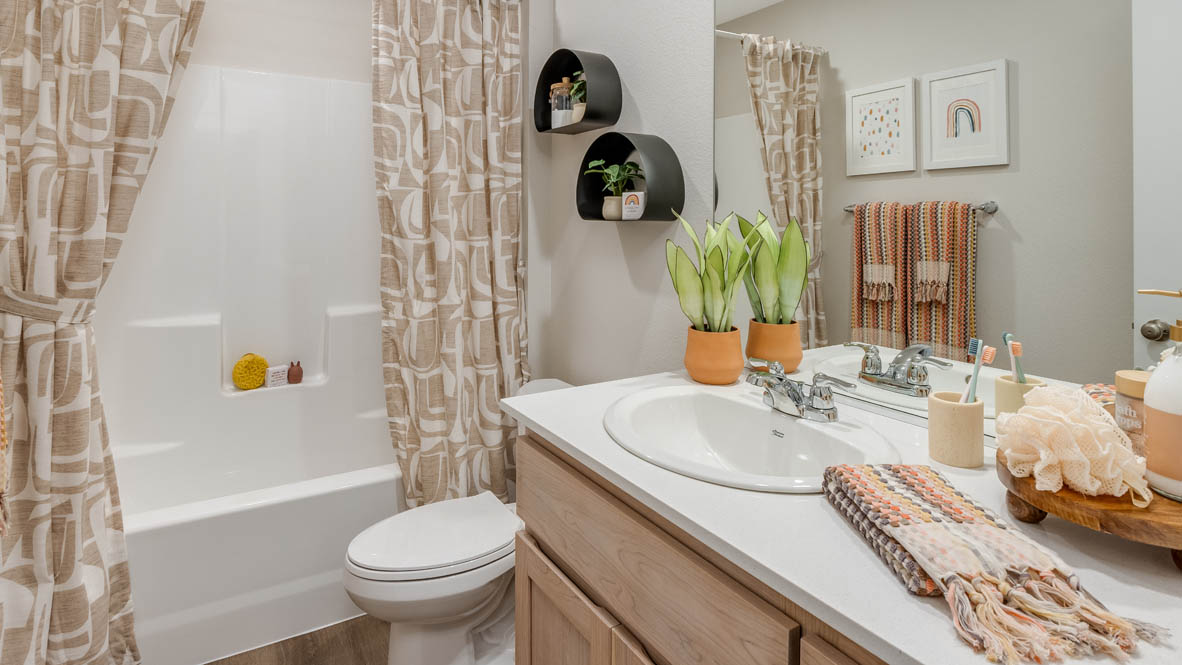 Blue Pearl secondary bathroom with tub shower and single sink vanity