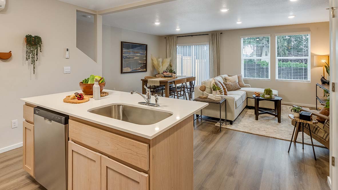Blue Pearl Kitchen with light wood cabinets and stainless steel appliances