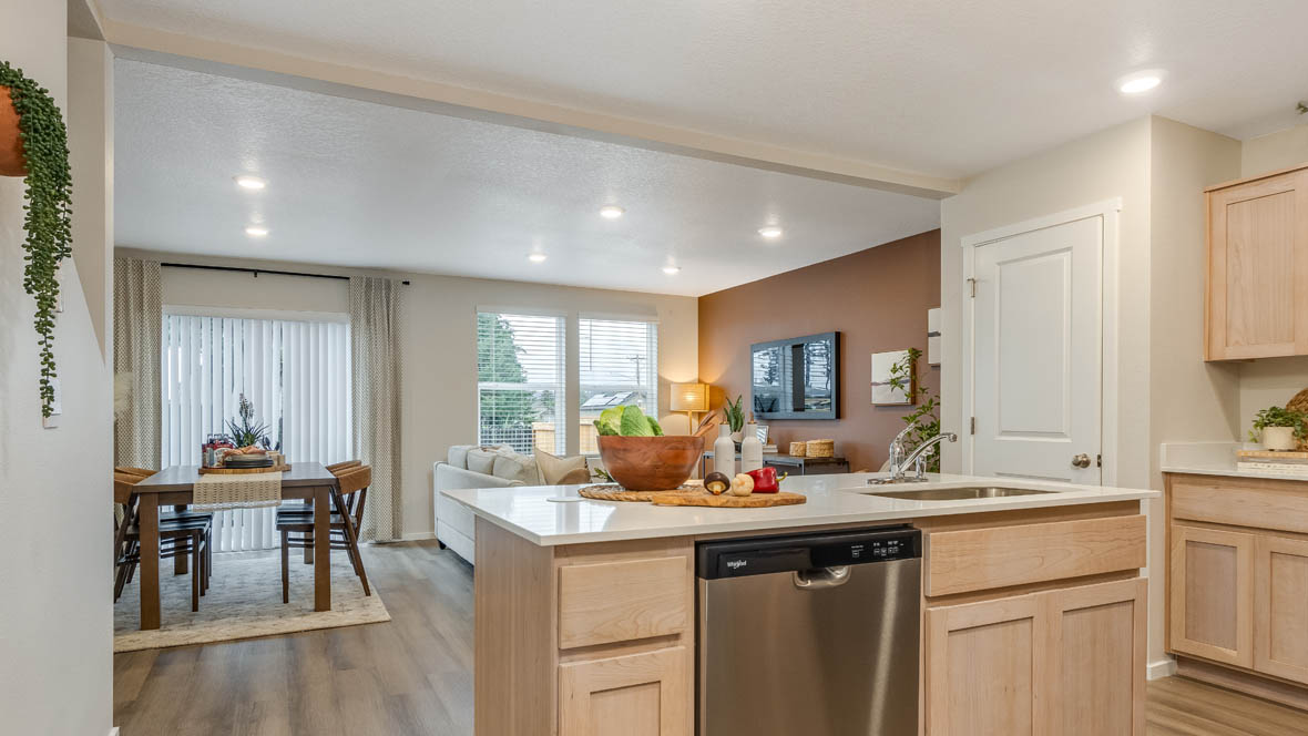 Blue Pearl Kitchen with light wood cabinets and stainless steel appliances
