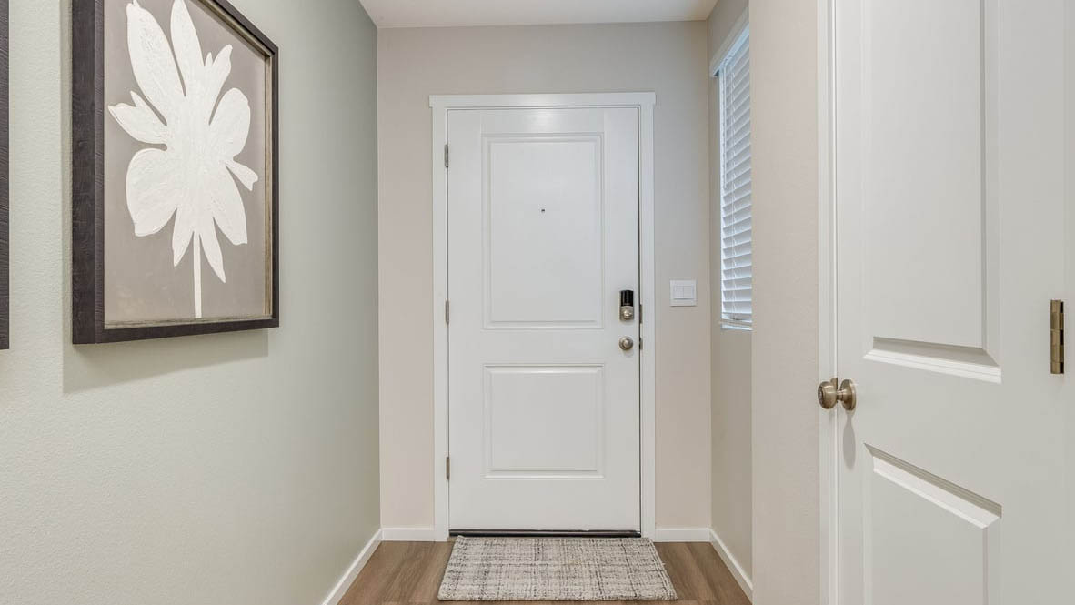 Entryway with a coat closet and laminate flooring