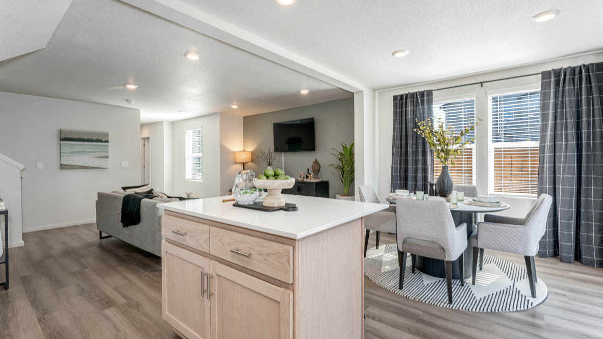 Blue Pearl kitchen with island, stainless steel appliances, dining table, quartz countertops, a cabinets