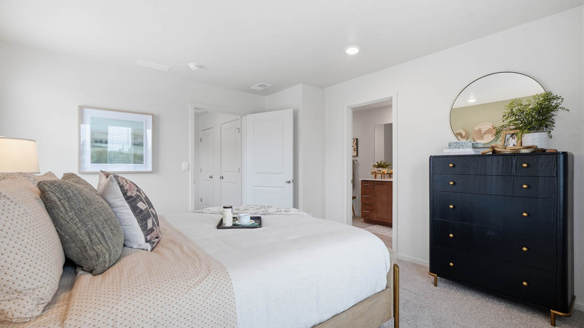 Primary bedroom with wall-to-wall carpet, a walk-in closet and an attached bathroom