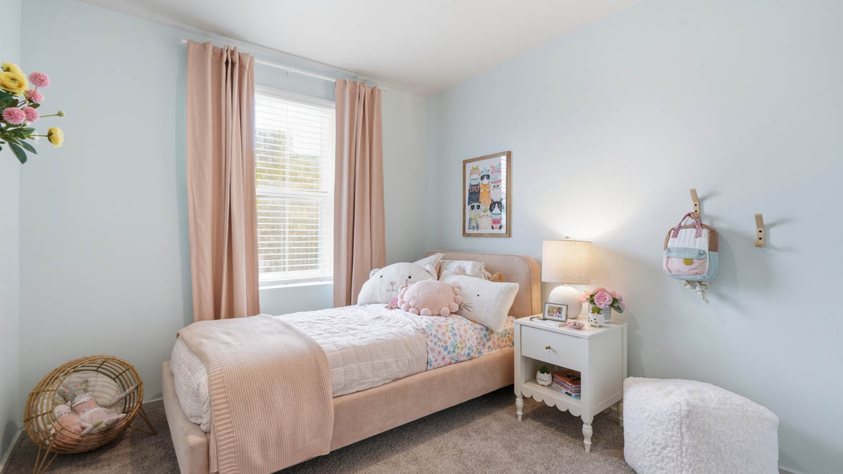 Bedroom with wall-to-wall carpet and a closet