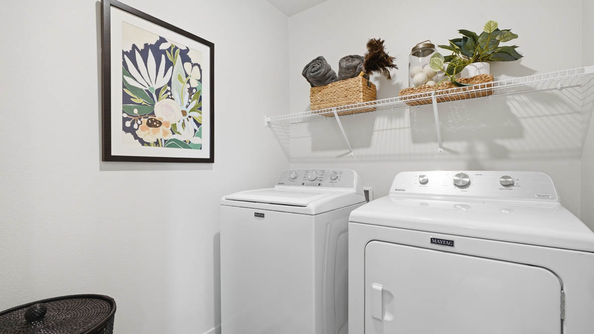 Laundry room with wire shelves and washer and dryer hookups