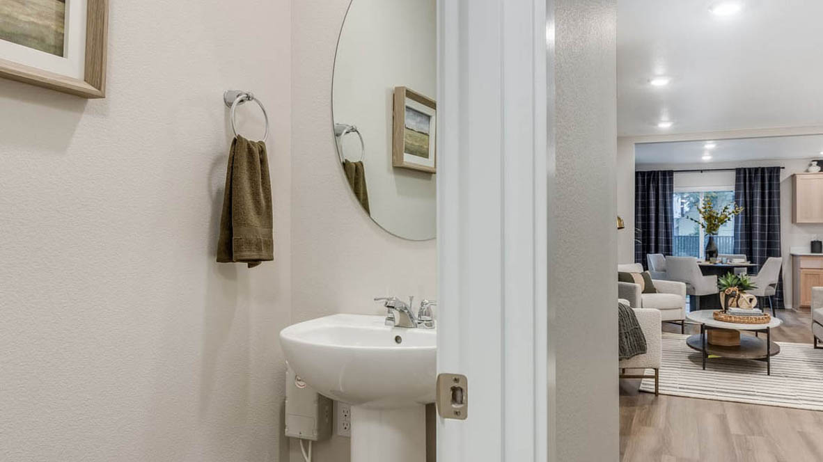 Blue Pearl Powder room with sink vanity and the great room in the background