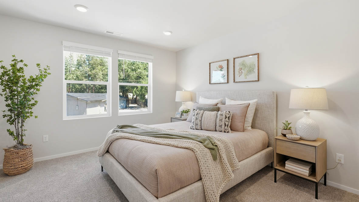 Thunder Ridge Primary Bedroom with carpet, a bed with blue bedding, nightstands with lamps, and windows