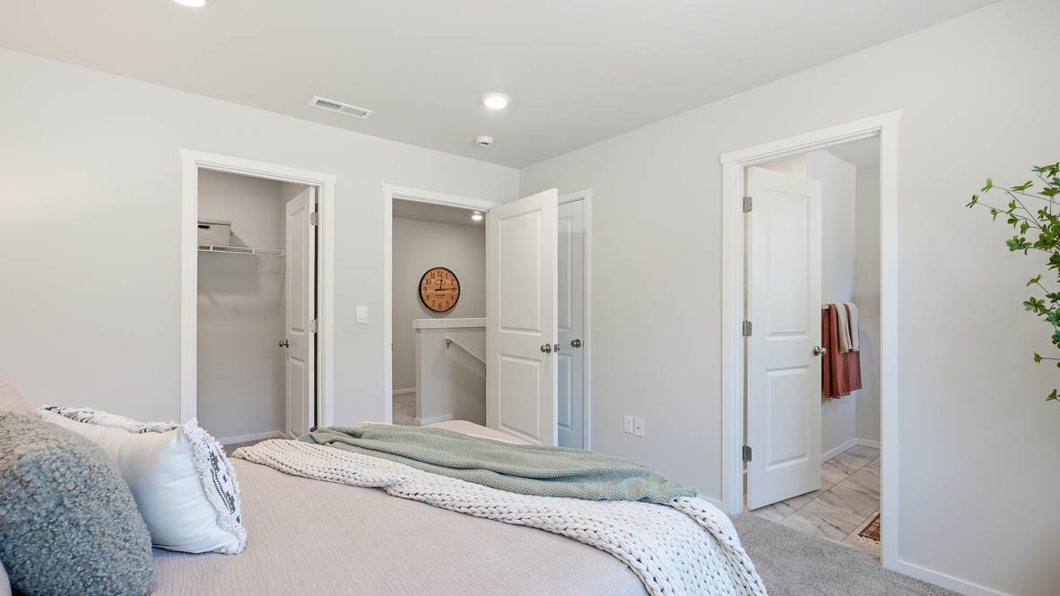 Thunder Ridge Primary Bedroom with carpet, a bed with blue bedding, nightstands with lamps, and windows