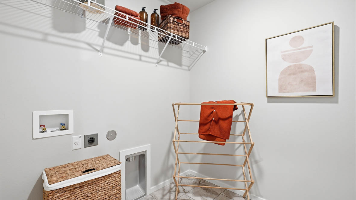 Thunder Ridge Laundry room with white walls, decorations, and white wire shelving