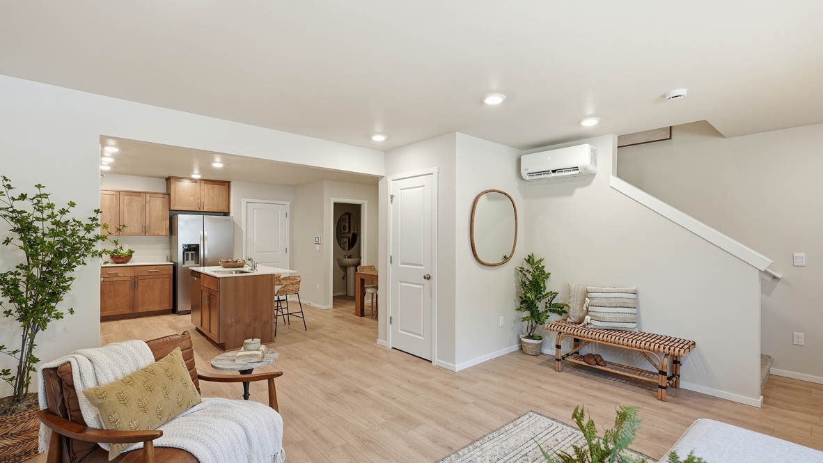 Thunder Ridge great room with wooden table and chairs set for four next to the kitchen