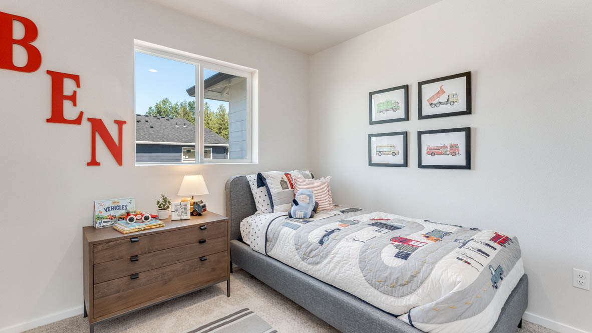 Thunder Ridge bedroom with a bed and bedding, a brown dresser, decorations, carpet, and window