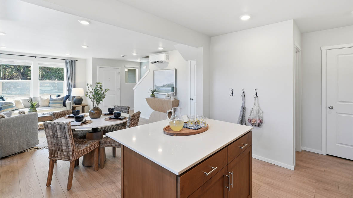 Thunder Ridge kitchen with stained shaker style cabinets and brushed nickel pulls with solid surface countertops and stainless steel appliances