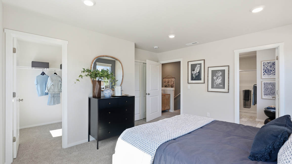 Thunder Ridge Primary Bedroom with carpet, a bed with blue bedding, nightstands with lamps, and windows