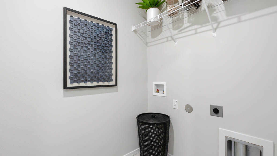 Thunder Ridge Laundry room with white walls, decorations, and white wire shelving