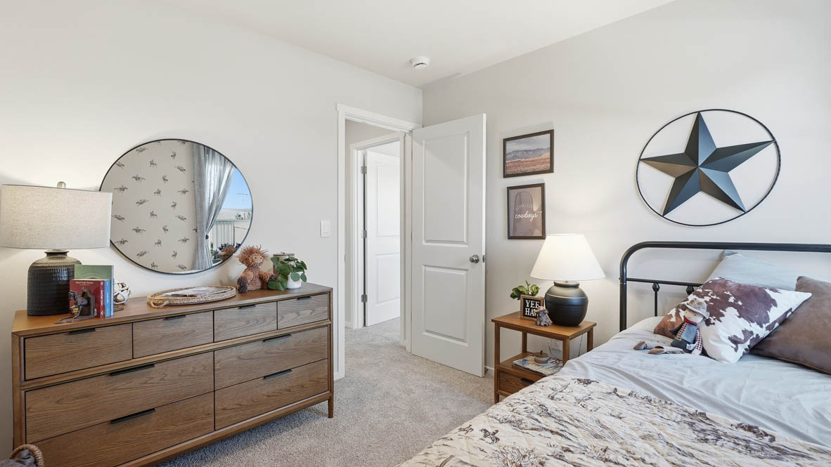 Thunder bedroom staged as an office with wooden furniture and wall hangings