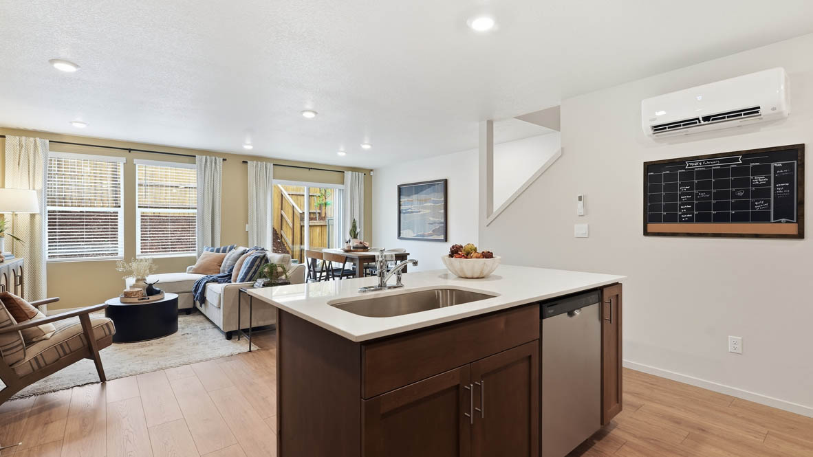 Thunder Ridge kitchen with laminate flooring, island, and stained cabinets