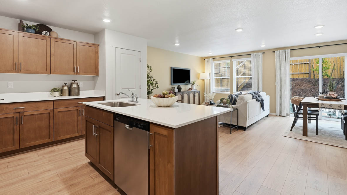 Thunder Ridge kitchen with laminate flooring, island, and stained cabinets