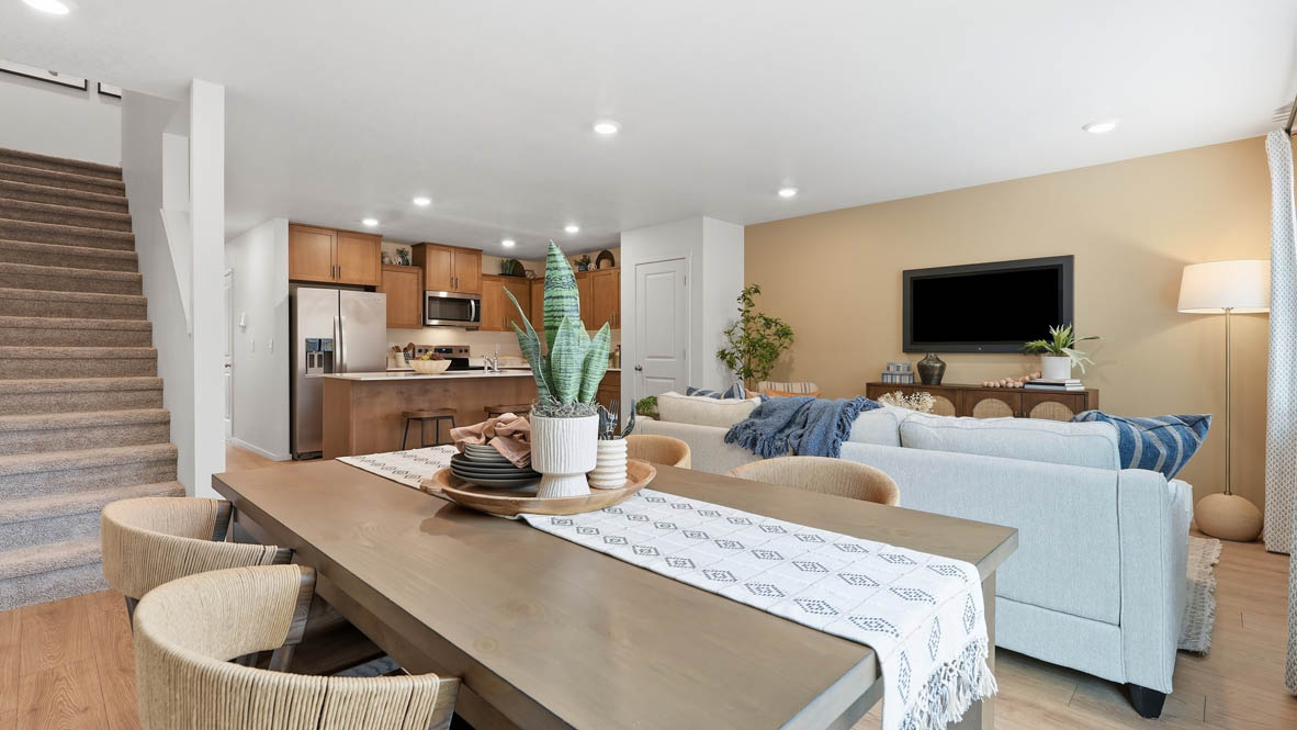 Thunder Ridge dining room with table, laminate flooring, great room, and kitchen