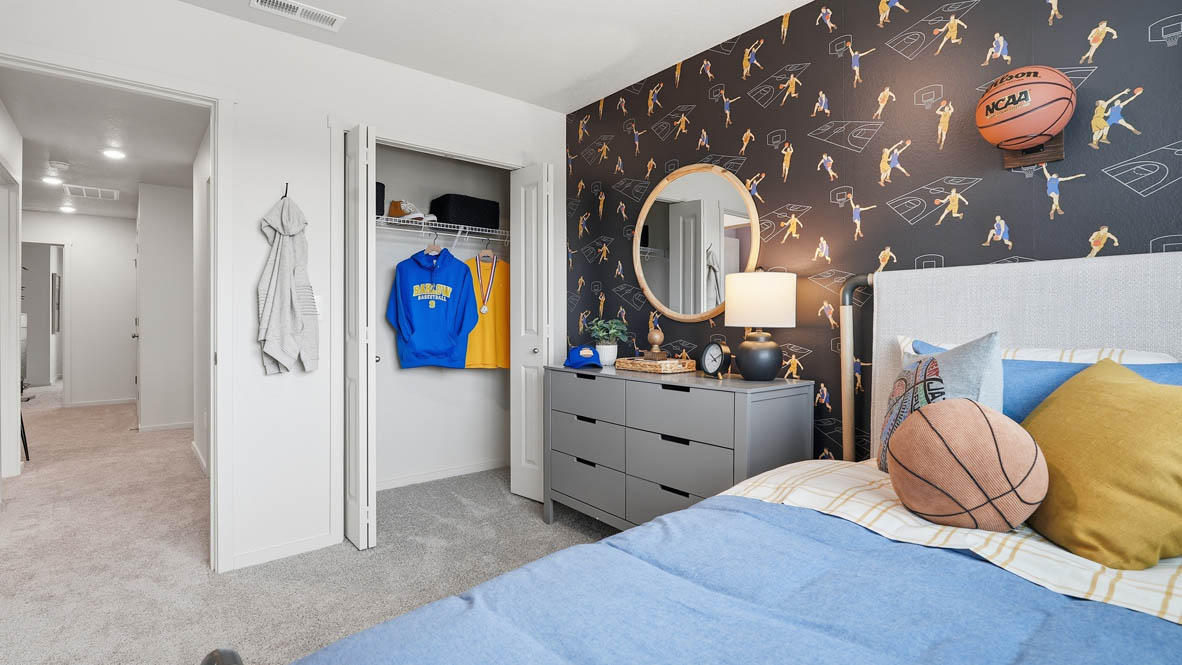 Thunder Ridge bedroom with accent wall, carpet, closet,  and gray furniture