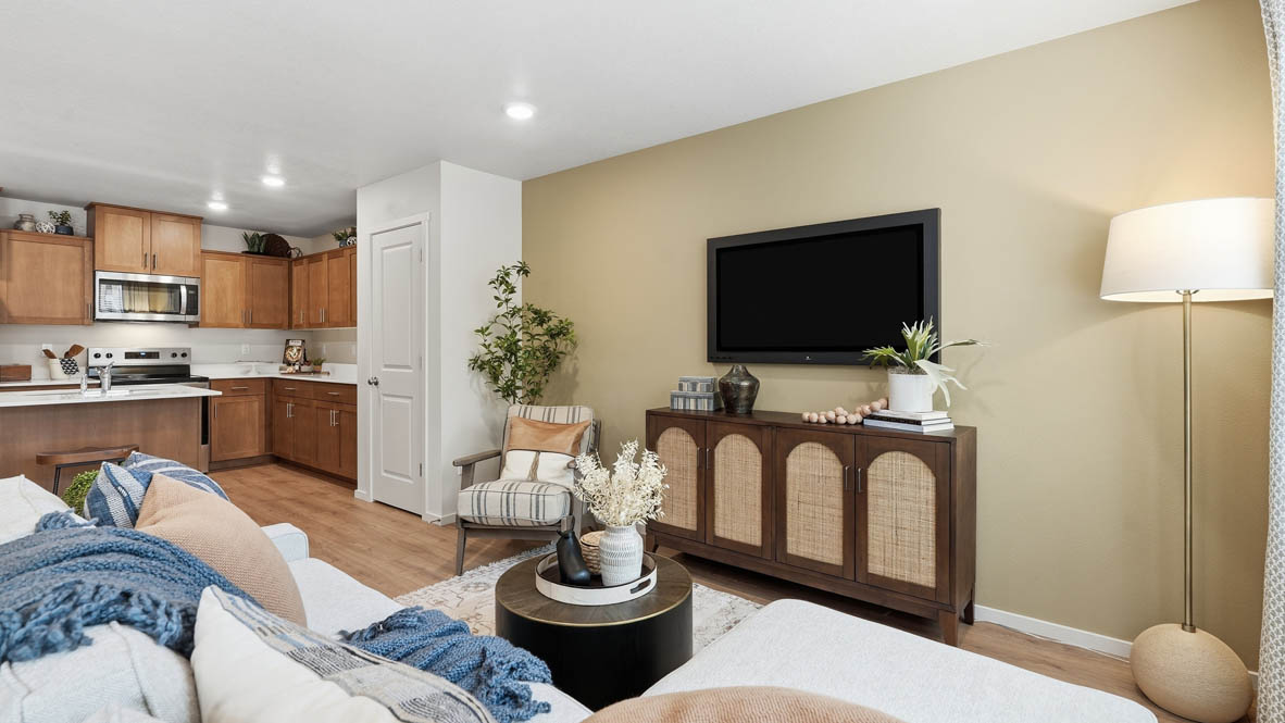 Thunder Ridge great room with laminate flooring, tv, and wood furniture