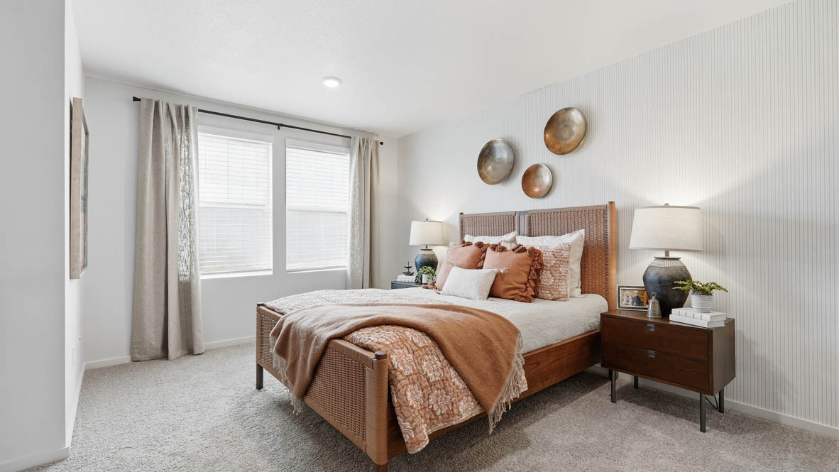 Thunder Ridge primary bedroom with white walls, carpet and wood furniture