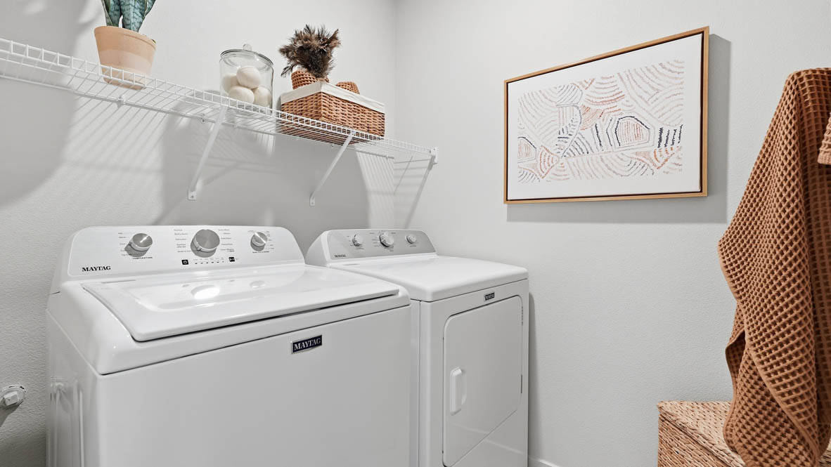Thunder Ridge laundry room with washer dryer and white wire shelving