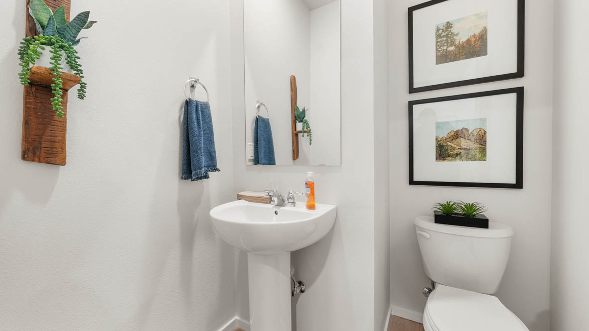 Ponderosa primary bedroom with carpet and with white accent wall and wooden side tables