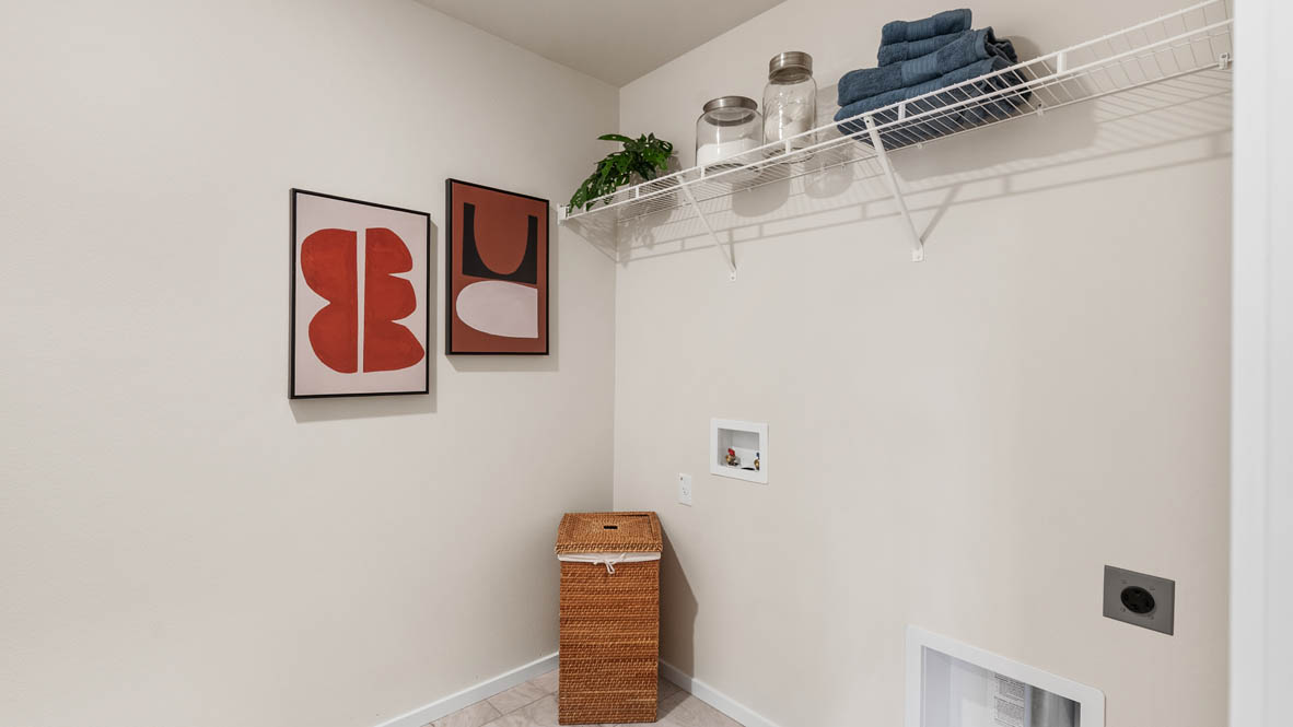 Ponderosa laundry room with white wire shelving and hooks for hanging pet leashes