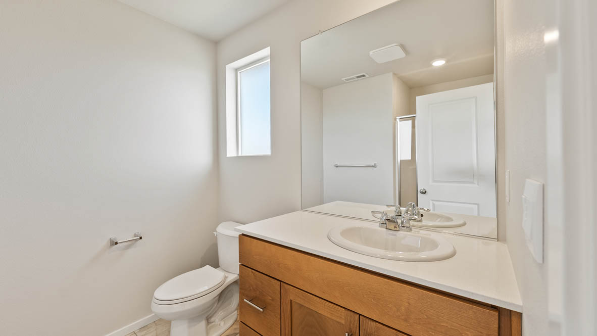 Ponderosa primary bathroom with single sink vanity and walk in shower