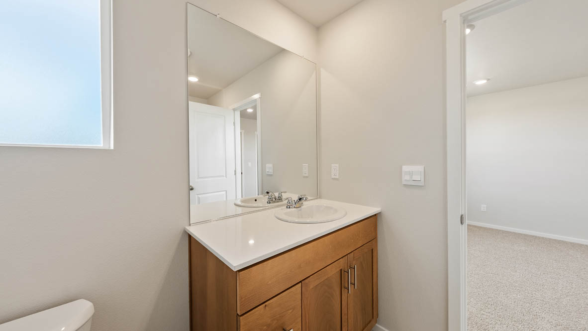 Ponderosa primary bathroom with single sink vanity and walk in shower