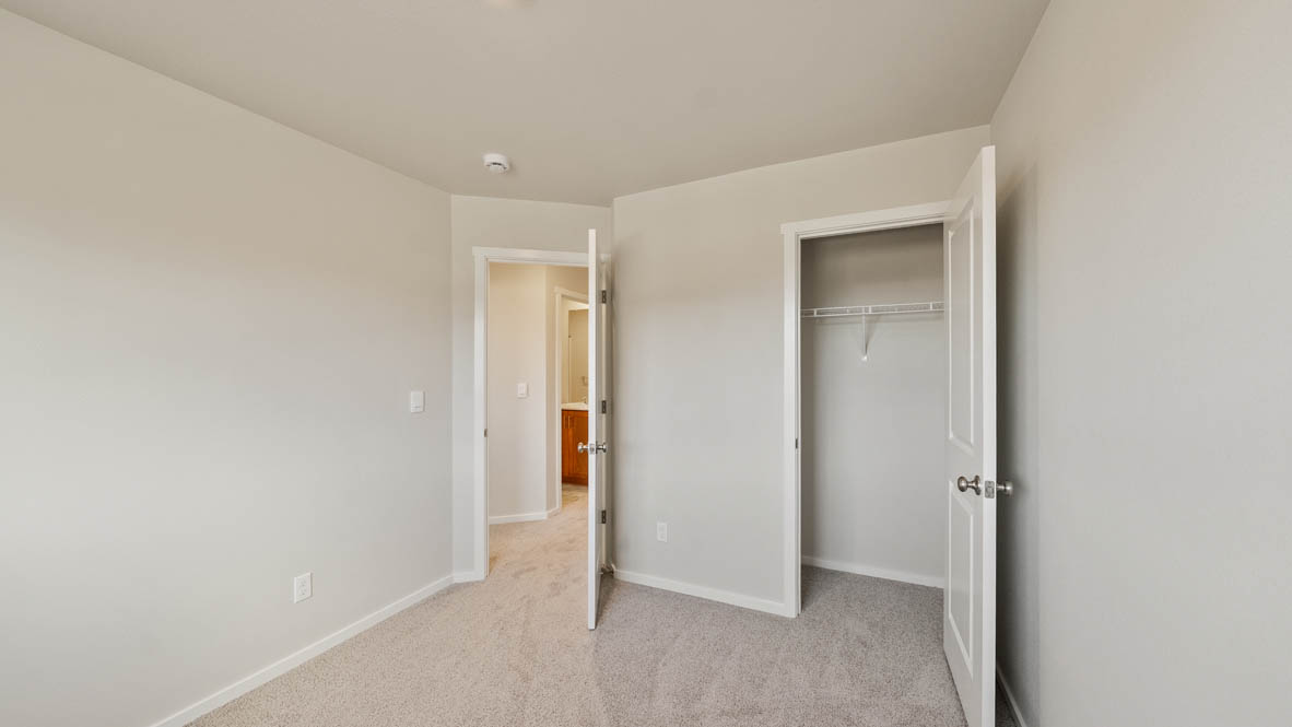 Ponderosa bedroom with carpeting and white walls and windows