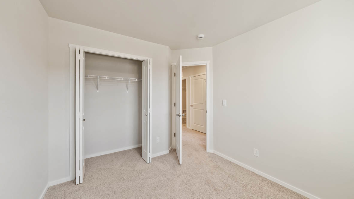 Ponderosa bedroom with carpeting and white walls and windows