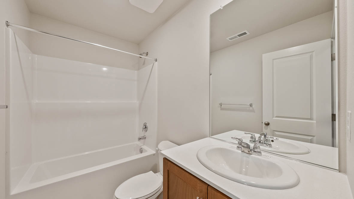 Ponderosa secondary bathroom with single sink vanity and tub shower