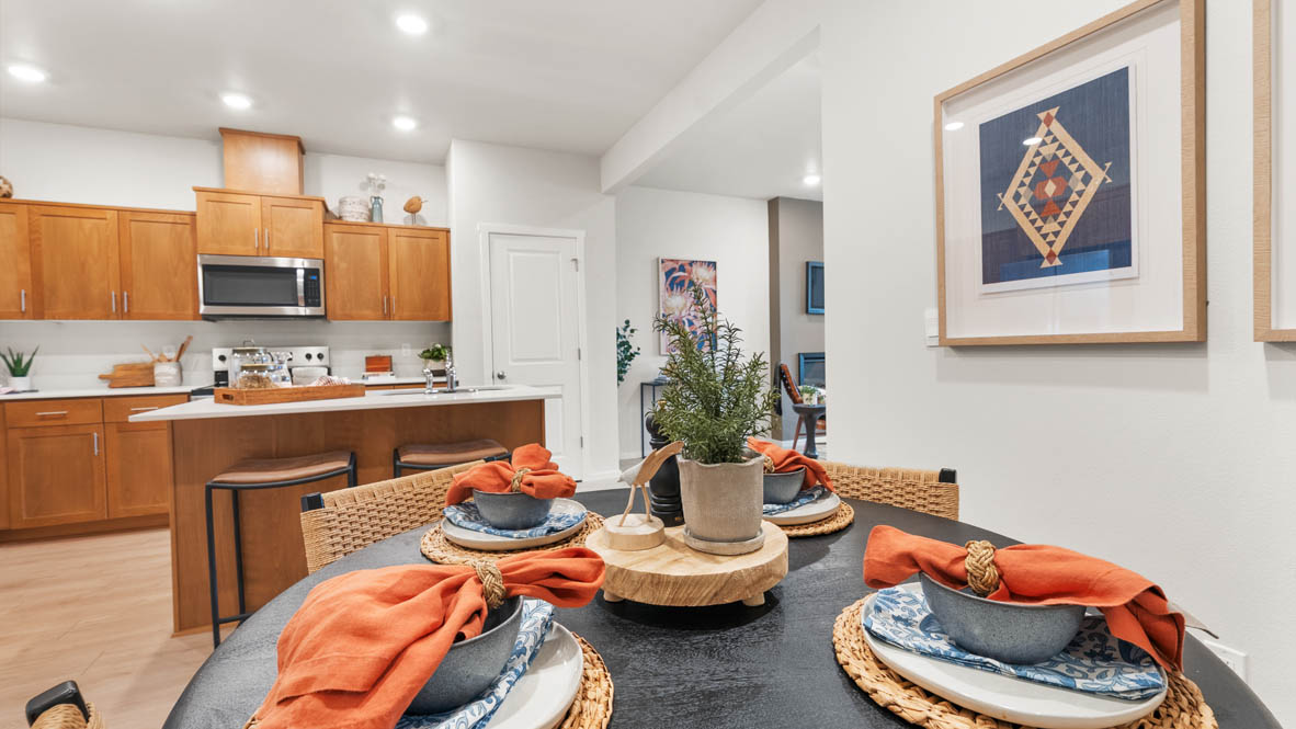 Ponderosa dining room with wooden table and chairs set for four next to the kitchen