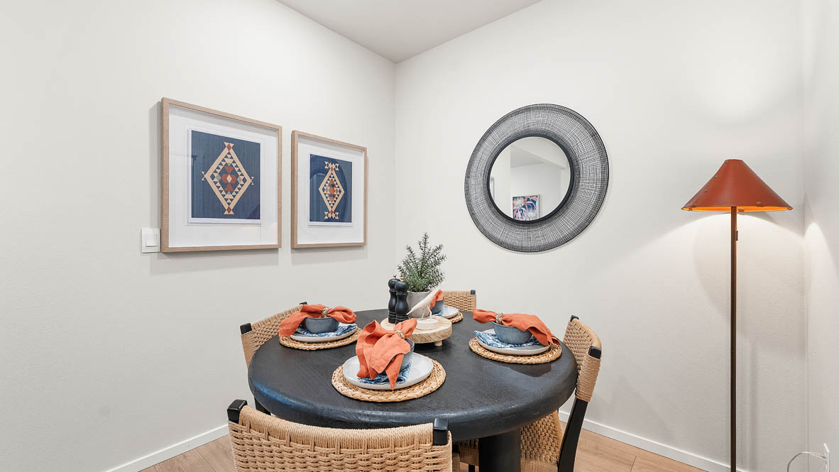Ponderosa dining room with wooden table and chairs set for four next to the kitchen