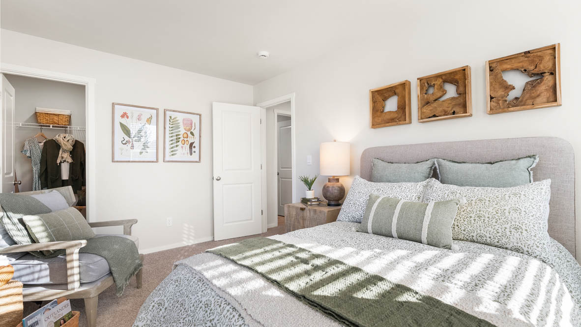 Ponderosa bedroom with green and wooden accents with carpeting and a walk in closet