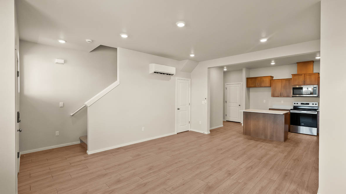 Ponderosa kitchen with stained shaker style cabinets and brushed nickel pulls with solid surface countertops and stainless steel appliances