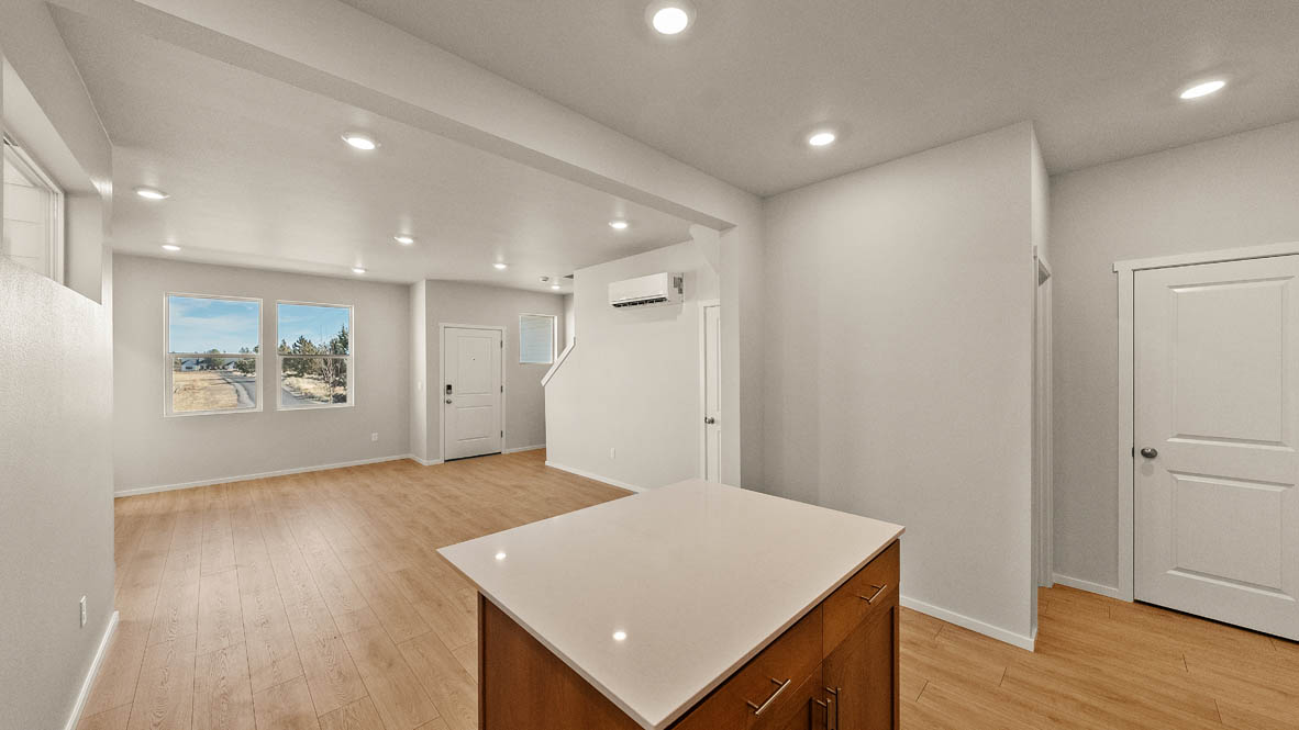 Ponderosa kitchen with stained shaker style cabinets and brushed nickel pulls with solid surface countertops and stainless steel appliances