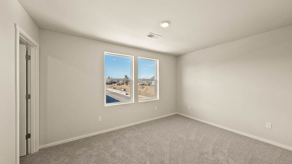 Ponderosa bedroom with carpeting and white walls and windows