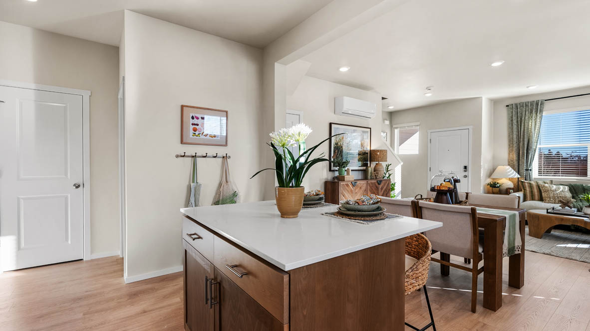 Ponderosa kitchen with stained shaker style cabinets and brushed nickel pulls with solid surface countertops and stainless steel appliances