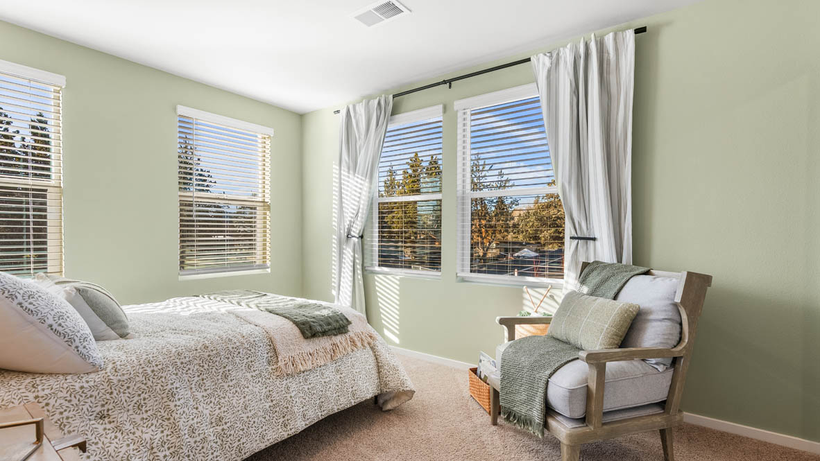 Ponderosa bedroom with green and wooden accents with carpeting and a walk in closet