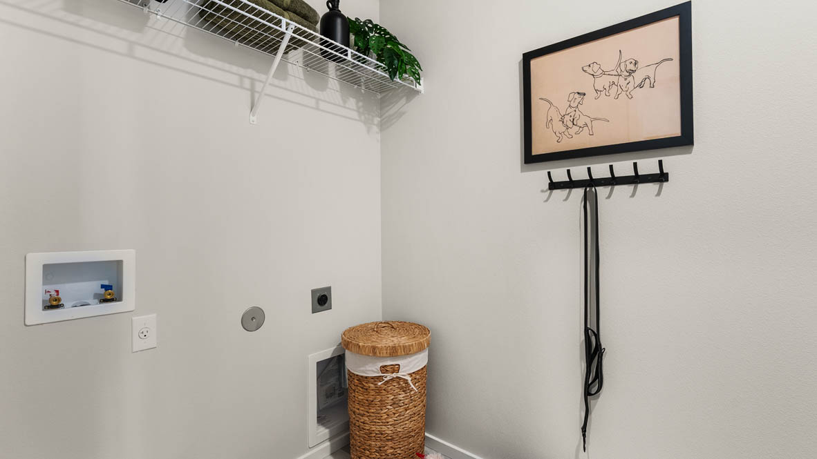 Ponderosa Laundry room with white walls, decorations, and white wire shelving