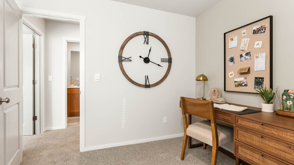 Ponderosa bedroom staged as an office with wooden furniture and wall hangings