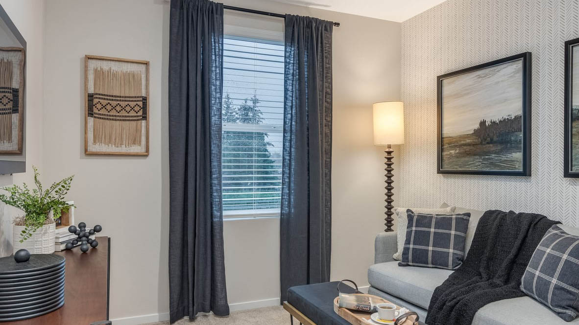 Ponderosa Bedroom with a bed, a lamp, bedside table with a book,  and window