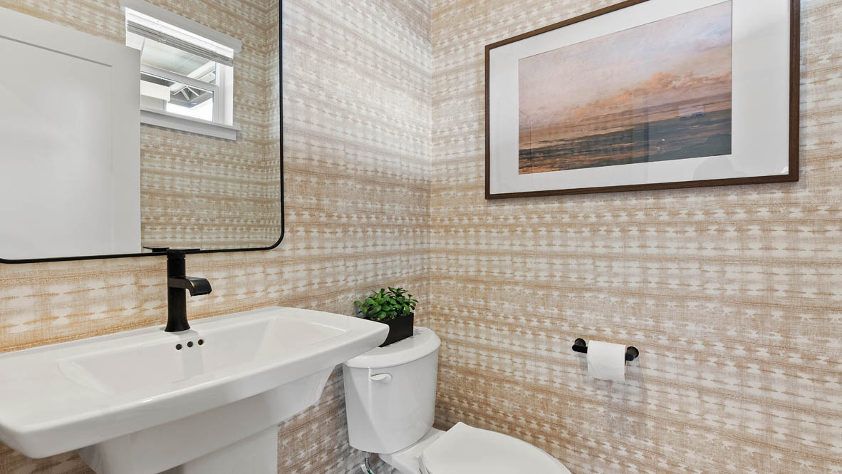 Stevens Ranch Diamond 3816 powder room with wall paper accent walls, a panting, toilet, single sink vanity, mirror