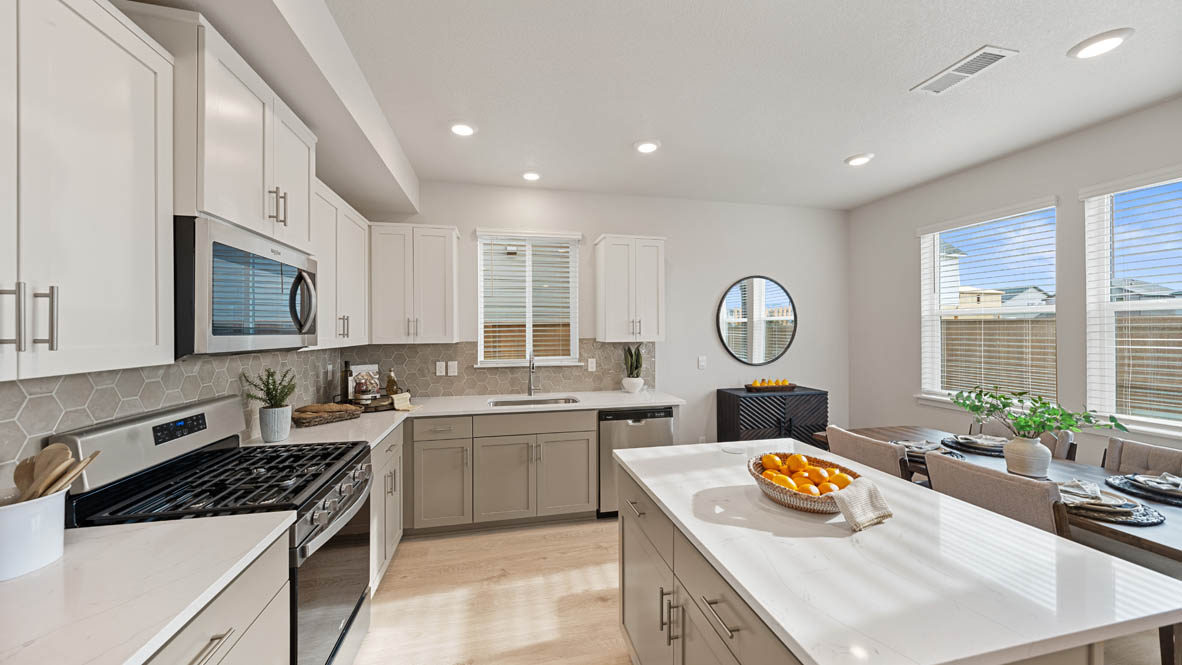 Stevens Ranch Kitchen with white quartz countertops, gray low cabinets, white upper cabinets, stainless steel appliances, window, and sink