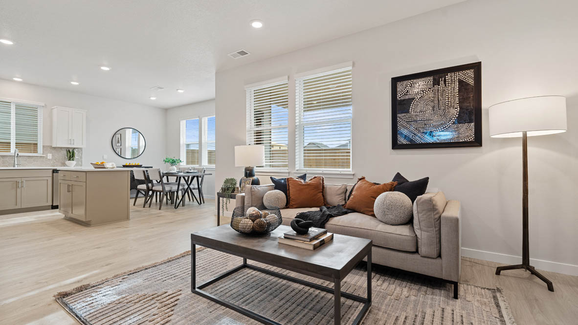 Stevens Ranch Stevens Ranch dining room with white couch, coffee table, paintings, windows, and laminate flooring