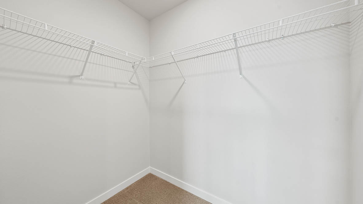 Stevens Ranch walk in closet with white wire shelving and white walls