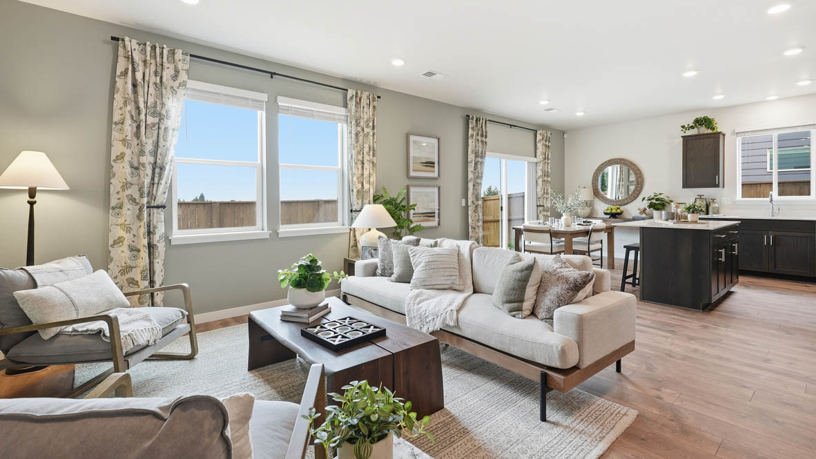 Stevens Ranch great room with couch and coffee table and two chairs with painted accent wall